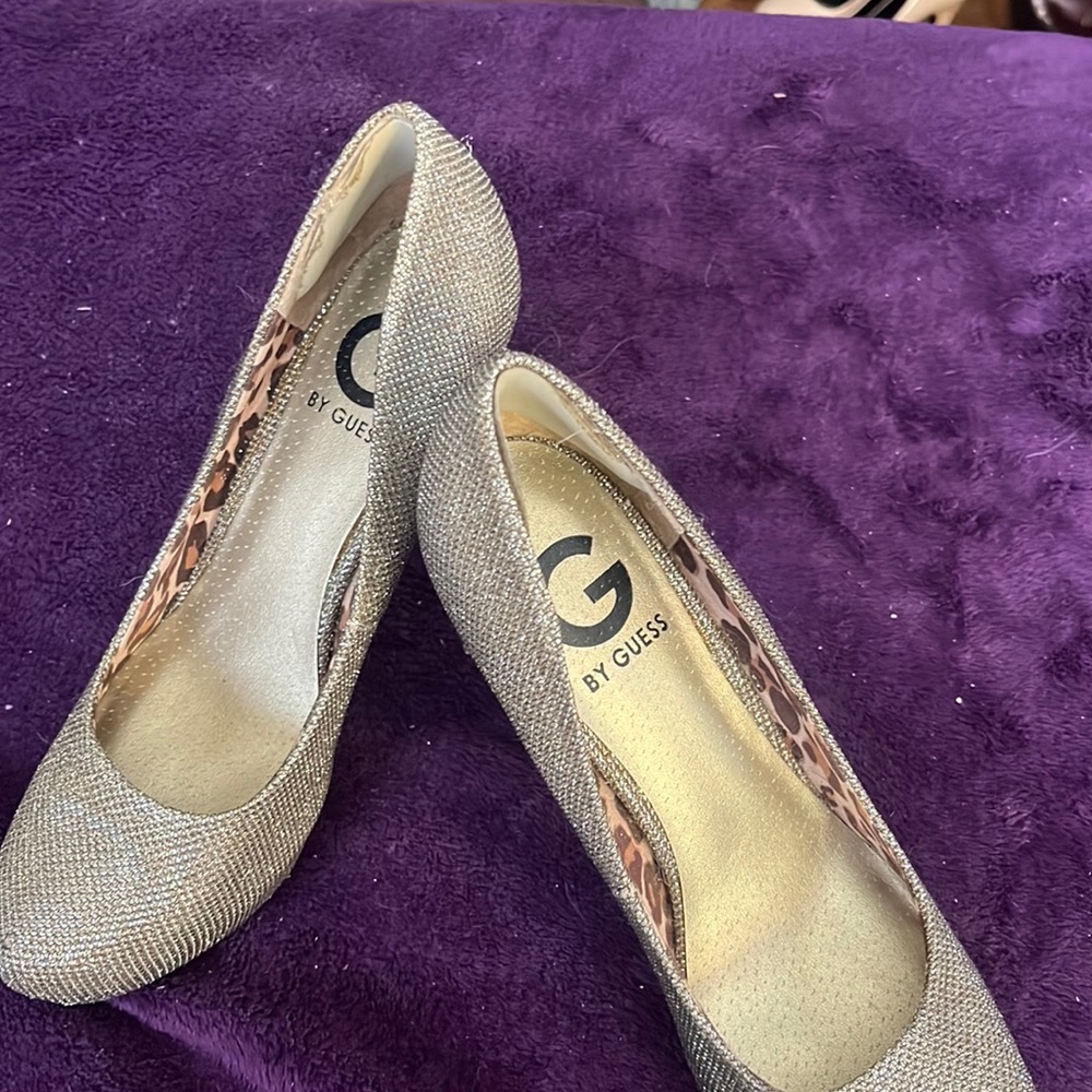One pair platform Guess gold glitter shoes.